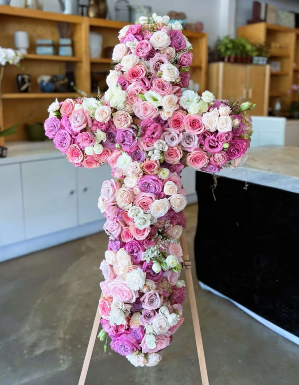 Pink Cross funeral floral arrangement, a respectful tribute featuring pink blooms arranged in the shape of a cross, ideal for memorials, funerals, and honoring loved ones, available for same-day delivery in Los Angeles