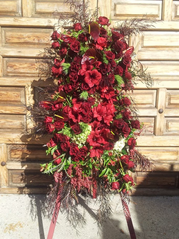 Red Funeral Spray floral arrangement, a beautiful and respectful tribute featuring red blooms, ideal for memorials and funerals, available for same-day delivery in Los Angeles.