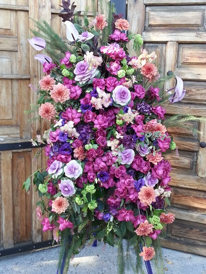 Prismatic Farewell funeral floral arrangement, a colorful and vibrant tribute featuring a mix of soft and bright blooms, ideal for memorials and funerals, available for same-day delivery in Los Angeles