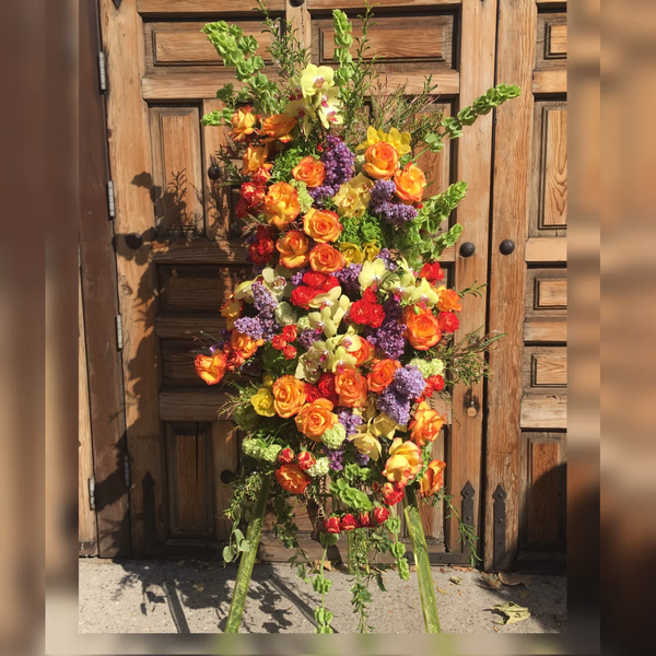 Warm Embrace funeral wreath, a respectful tribute featuring soft and comforting blooms, ideal for memorials and funerals, available for same-day delivery in Los Angeles