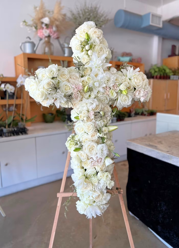 Graceful white cross floral arrangement, a meaningful tribute, available for same-day delivery in West Los Angeles